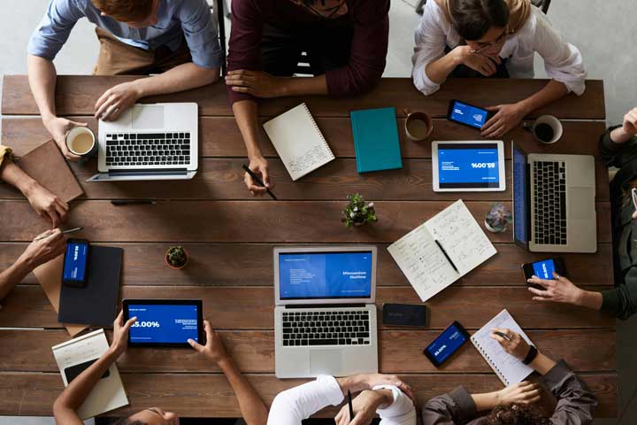 Group of people gathered around a desk